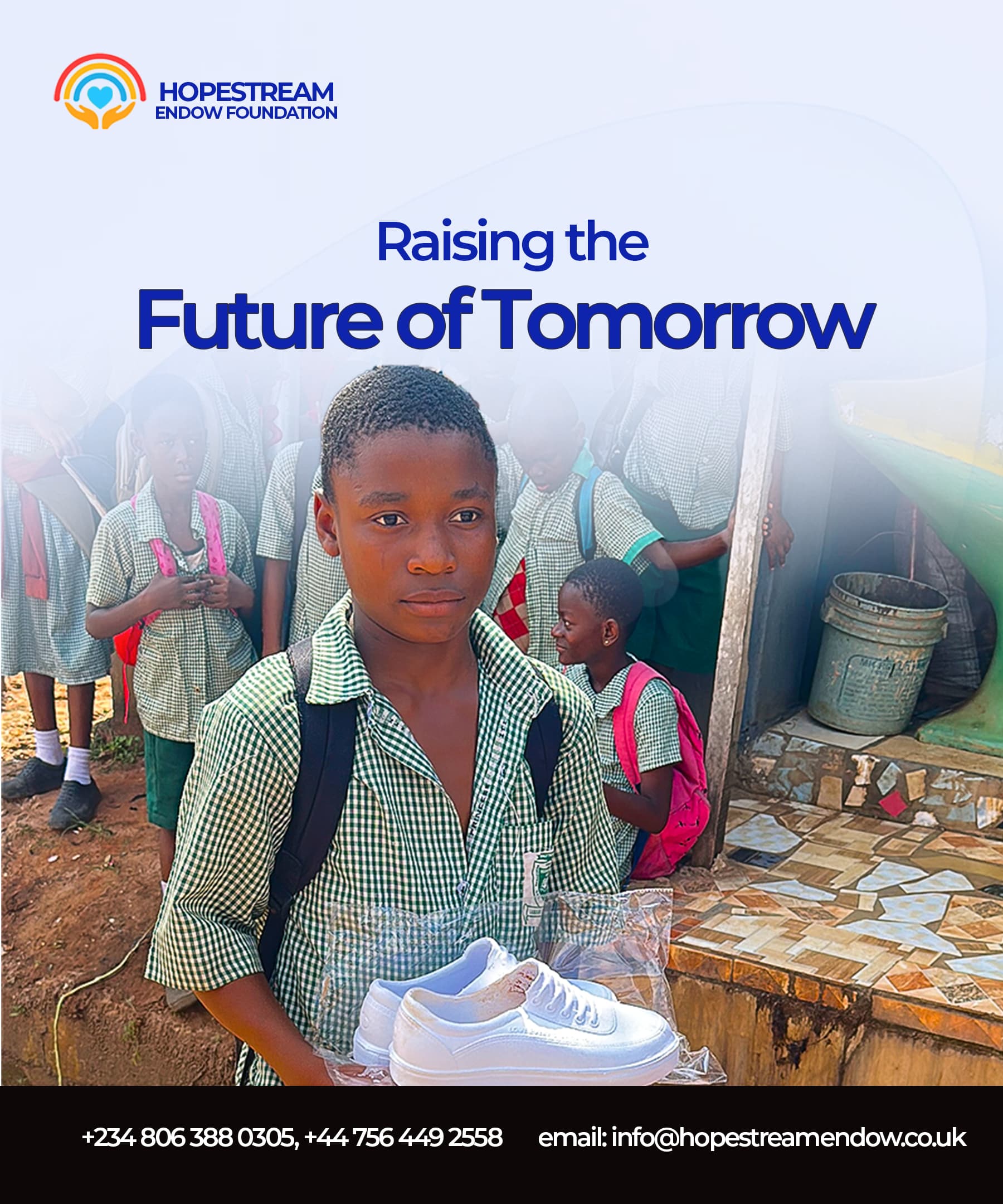 A schoolboy holding a pair of new shoes donated through HopeStream